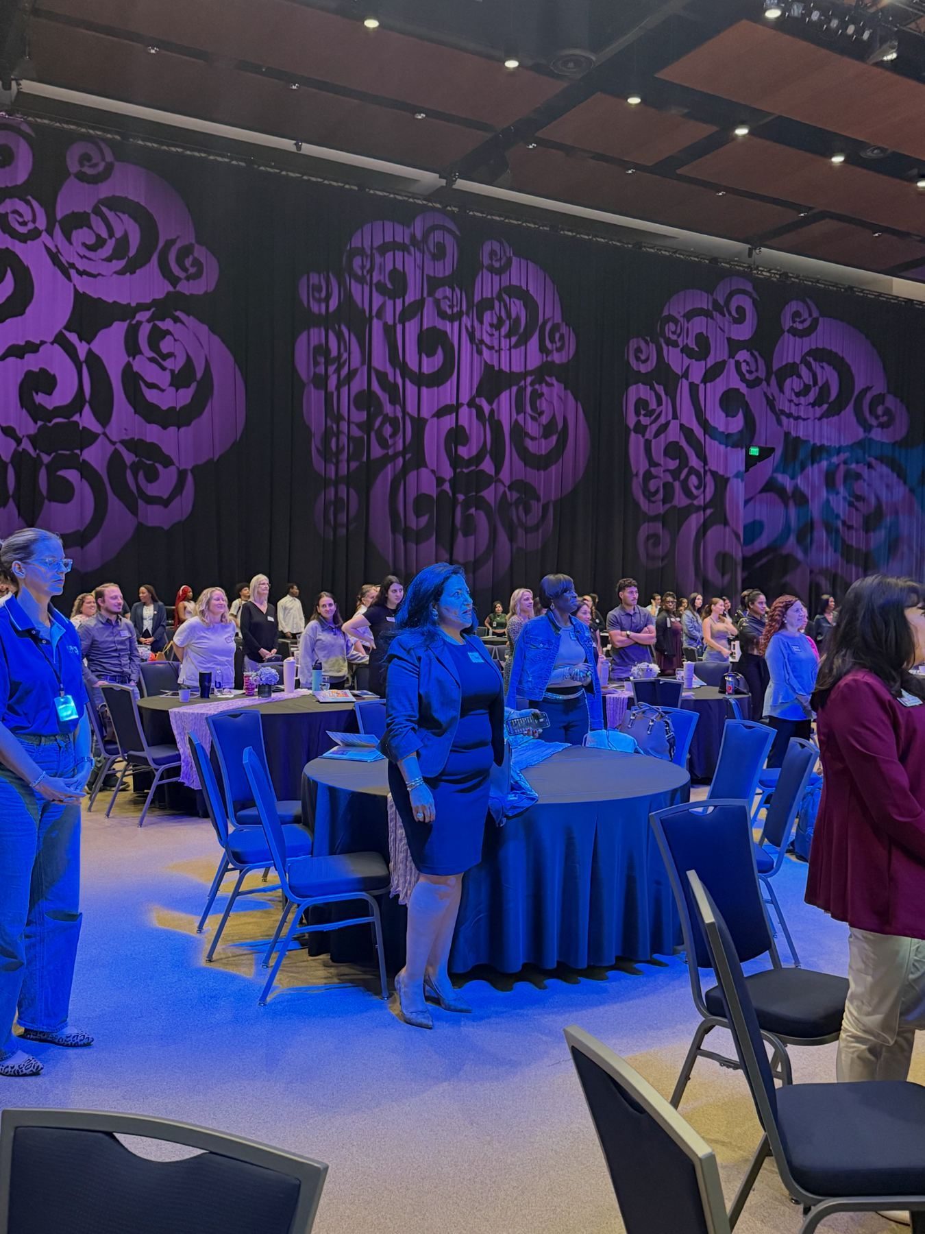 Summit group on stage in front of event screen