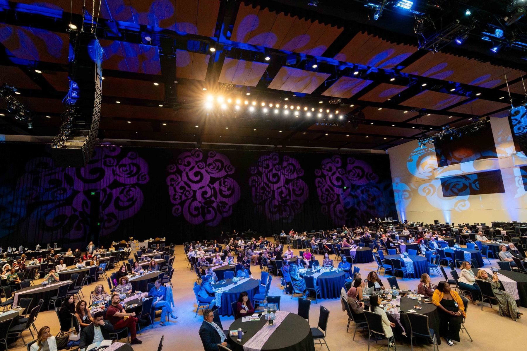 Wide view of summit ballroom and stage programming