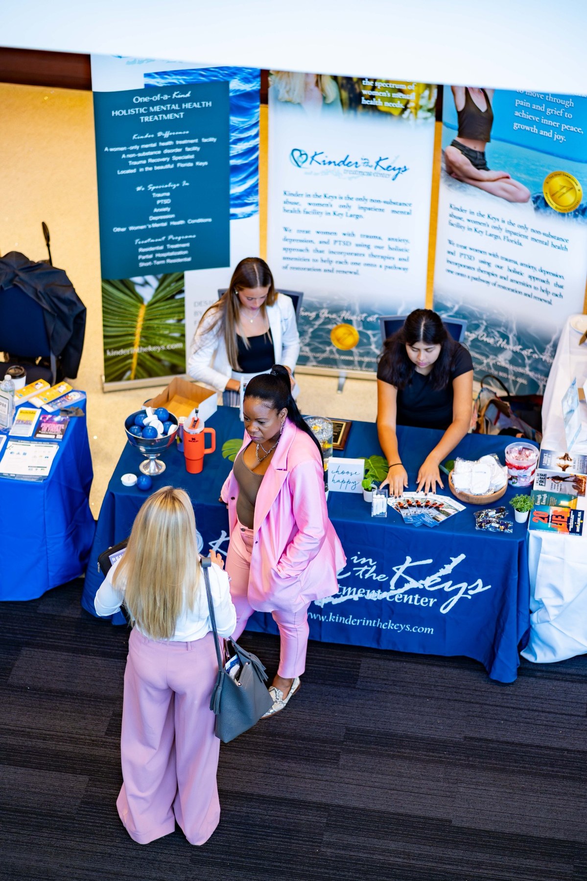 Top-down view of exhibitor booth conversations